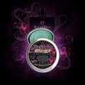 Black Opium Conditioner Bar by Jungle Gardens Sweet Scent, shown in a silver tin with a teal conditioner bar, surrounded by orchids and moody purple smoke